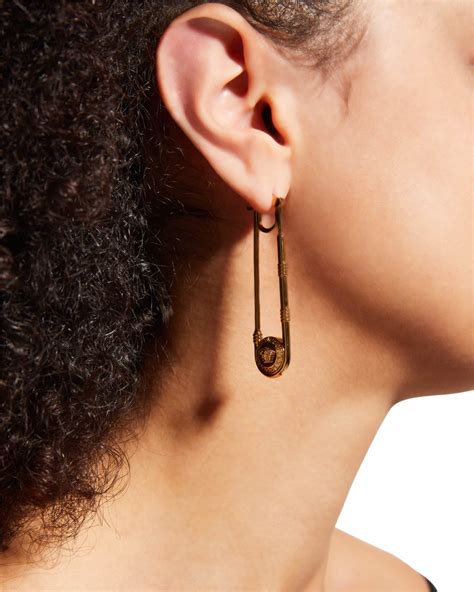 versace elongated medusa earrings.